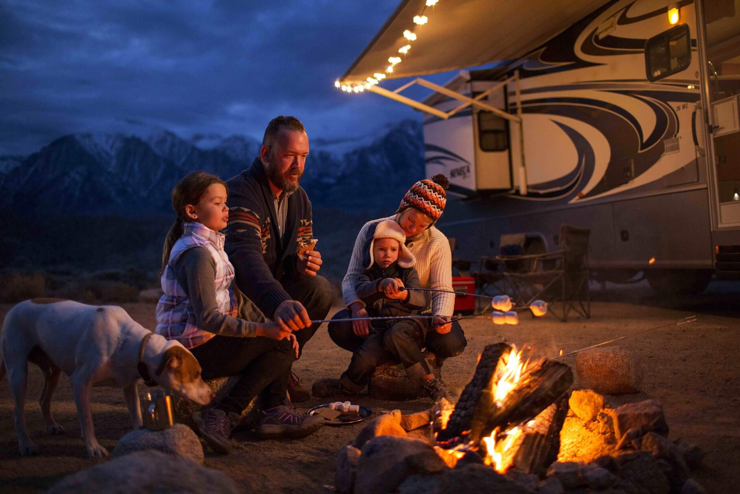 a group of people sitting around a fire